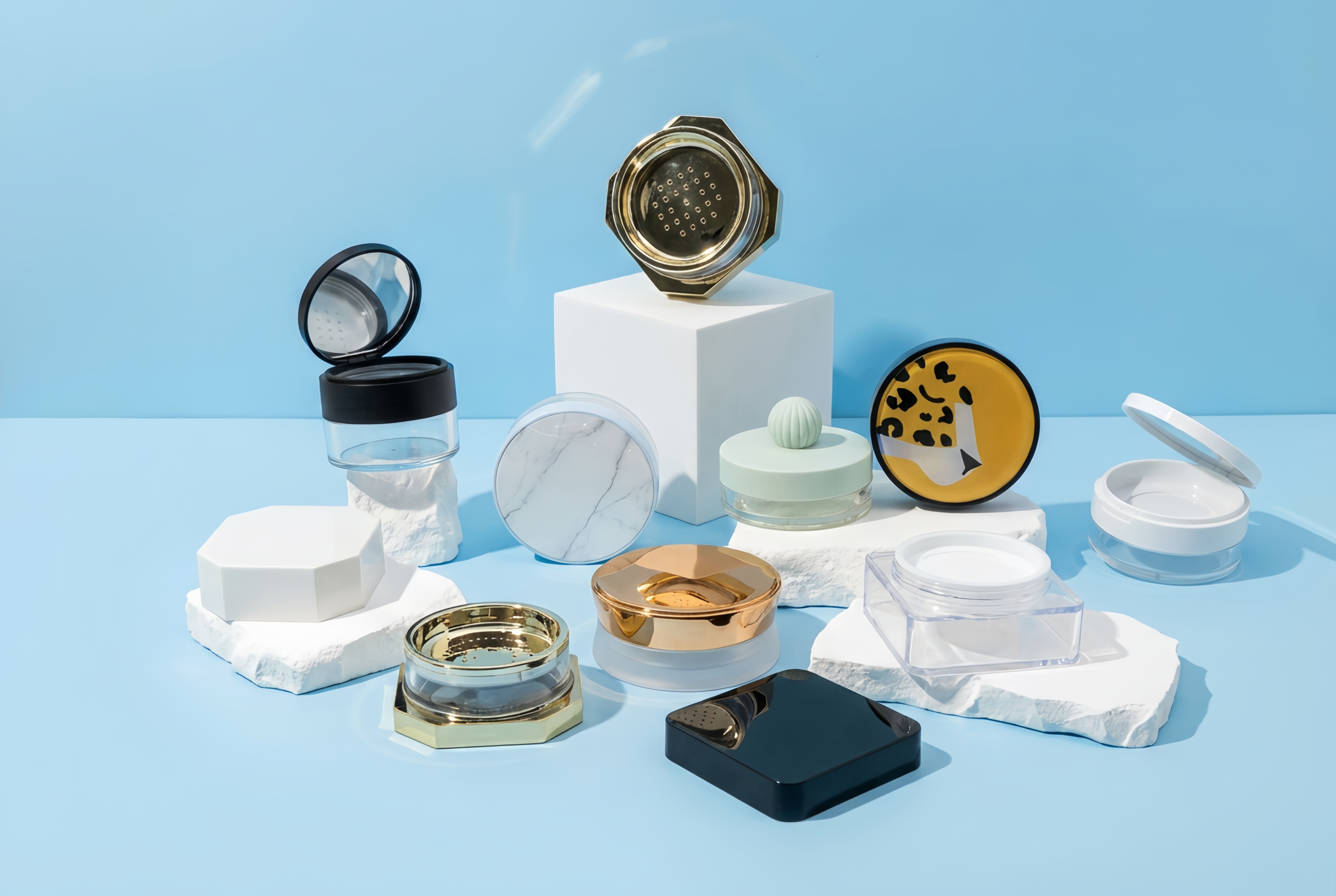 Collection of empty loose powder jars featuring gold hexagon, marble print, and black flip-top styles with sifters, manufactured by China factory.